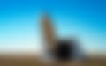 desert-scene-with-silvery-airship-floating-into-sky-launched-from-an-aircraft-hangar.webp